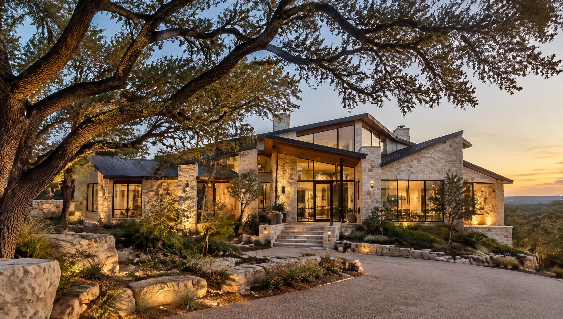 Modern limestone home with live oak trees in Austin, Texas at golden hour